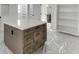 Kitchen island with counter seating, drawers, and cabinets; unfinished room at 2427 Wolf Meadow Ln, Buford, GA 30518