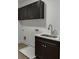 Laundry room with cabinets, stainless steel sink, white countertop, and wood-style flooring at 2427 Wolf Meadow Ln, Buford, GA 30518