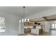 Open-concept layout showcasing a modern kitchen with island seating and an adjacent living space with large windows at 2427 Wolf Meadow Ln, Buford, GA 30518