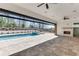 Covered patio area with a pool, a fireplace, and retractable screens at 2427 Wolf Meadow Ln, Buford, GA 30518