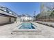 An inviting backyard pool and spa with an extensive stone tile surround, adjacent to the home at 2427 Wolf Meadow Ln, Buford, GA 30518
