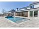 A beautiful backyard pool with a fountain feature is surrounded by patio, landscaping, and outdoor kitchen at 2427 Wolf Meadow Ln, Buford, GA 30518