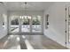 Bright sunroom features shiplap walls, large windows, and views of the pool and landscaped backyard at 2427 Wolf Meadow Ln, Buford, GA 30518