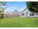Fenced backyard with lush grass and landscaping at 621 Shadow Lake Dr, Lithonia, GA 30058