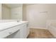 Bright bathroom featuring white cabinets and a separate bathtub at 621 Shadow Lake Dr, Lithonia, GA 30058