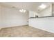 Dining area with wainscoting and view to kitchen, featuring modern lighting at 621 Shadow Lake Dr, Lithonia, GA 30058