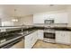 Modern kitchen with stainless steel appliances, dark countertops, and white cabinetry at 621 Shadow Lake Dr, Lithonia, GA 30058