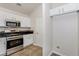 Well-lit kitchen features stainless steel appliances, granite countertops, and white cabinets at 621 Shadow Lake Dr, Lithonia, GA 30058