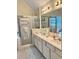 Bathroom featuring double sinks, shower with glass door, and neutral tile flooring at 1959 Firelight Ln, Buford, GA 30519