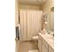 Cozy bathroom featuring neutral walls, patterned shower curtain, and a decorative shelf at 1959 Firelight Ln, Buford, GA 30519