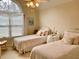 Charming bedroom with twin beds, soft linens, and a large arched window at 1959 Firelight Ln, Buford, GA 30519