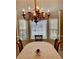 Elegant dining room featuring a chandelier, bay window, and formal table setting at 1959 Firelight Ln, Buford, GA 30519
