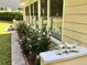 Exterior home details with blooming roses, manicured landscaping, and natural light at 1959 Firelight Ln, Buford, GA 30519