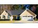 Charming single-story home with a well-manicured lawn and attached two-car garage at 1959 Firelight Ln, Buford, GA 30519