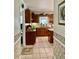 Well-maintained kitchen boasts wood cabinets, tile flooring, and ample counter space at 1959 Firelight Ln, Buford, GA 30519