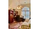 Comfortable home office featuring a vaulted ceiling, built-in bookcase, and large arched window at 1959 Firelight Ln, Buford, GA 30519