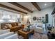 Open-concept living room with exposed beams connected to a modern kitchen at 515 Danube Rd, Atlanta, GA 30342