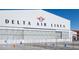 Full view of the Delta Air Lines hangar and support buildings surrounded by fencing and a paved apron at 125 Silvia Ln # 24, Hapeville, GA 30354