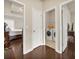 View of hallway with white doors leading to a bedroom and a laundry area with a washer and dryer at 2659 Village Park Bnd, Duluth, GA 30096