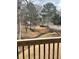 Backyard view featuring trees and a small creek seen from the wooden porch at 1391 Old Coach Sw Rd, Marietta, GA 30008
