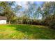 Expansive green backyard perfect for outdoor activities with a backdrop of lush trees at 221 Cobb St, Palmetto, GA 30268
