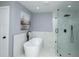 Bathroom featuring a modern freestanding tub and a glass-enclosed shower with black hardware at 221 Cobb St, Palmetto, GA 30268