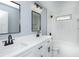 Sleek bathroom with double vanity, modern fixtures, and a tub/shower combination with white tiling at 221 Cobb St, Palmetto, GA 30268