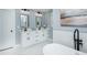 Modern bathroom with double vanity, stylish lighting, and a freestanding tub at 221 Cobb St, Palmetto, GA 30268