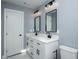 Modern bathroom featuring dual sinks, white cabinetry, and sleek black fixtures at 221 Cobb St, Palmetto, GA 30268