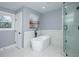 Contemporary bathroom featuring a freestanding tub, glass enclosed shower, marble tile and modern fixtures at 221 Cobb St, Palmetto, GA 30268