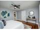 Bedroom featuring a ceiling fan, wood floors, natural light, and modern decor at 221 Cobb St, Palmetto, GA 30268
