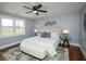 Comfortable bedroom with a ceiling fan, a large window, a cozy bed, and stylish decor at 221 Cobb St, Palmetto, GA 30268