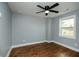 Light-filled bedroom with hardwood floors, a modern ceiling fan, and neutral walls at 221 Cobb St, Palmetto, GA 30268