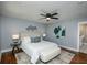 Bedroom featuring a ceiling fan, wood floors, natural light, and modern decor at 221 Cobb St, Palmetto, GA 30268