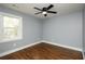 Comfortable bedroom featuring hardwood floors, a modern ceiling fan, and ample natural light at 221 Cobb St, Palmetto, GA 30268