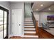 Inviting entryway featuring wood floors, staircase, and a view into the living area at 221 Cobb St, Palmetto, GA 30268