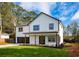 Charming two-story home with black trimmed windows, a well-manicured lawn and inviting, covered front entry at 221 Cobb St, Palmetto, GA 30268
