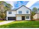Charming two-story home with black trimmed windows, a well-manicured lawn and inviting, covered front entry at 221 Cobb St, Palmetto, GA 30268