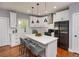 Modern kitchen featuring stainless steel appliances, quartz countertops, and a large island with seating at 221 Cobb St, Palmetto, GA 30268