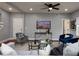 Well-lit living room boasts hardwood floors, modern furniture, and a decorative TV display at 221 Cobb St, Palmetto, GA 30268