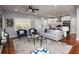 Bright living room connecting to a contemporary kitchen with sleek countertops and modern decor at 221 Cobb St, Palmetto, GA 30268