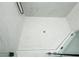 Modern shower featuring white marble-style tile and penny tile flooring with glass door and black hardware at 221 Cobb St, Palmetto, GA 30268