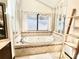 Elegant bathroom with a soaking tub, decorative mirrors, and a large window at 3150 Bolero Dr, Atlanta, GA 30341