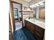 Bathroom with wooden vanity and a view through the open door to the bedroom at 3150 Bolero Dr, Atlanta, GA 30341