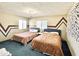 Bedroom with two beds and bright accent paint at 3150 Bolero Dr, Atlanta, GA 30341