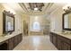 Large bathroom with double vanity, jacuzzi tub, arched window, and a glass shower at 1235 Seale Dr, Alpharetta, GA 30022