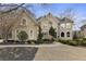 Elegant two-story home with a landscaped front yard and classic architectural details at 1235 Seale Dr, Alpharetta, GA 30022