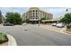 Street view of a building at Avalon with a roundabout, sidewalks, and parked cars at 1235 Seale Dr, Alpharetta, GA 30022