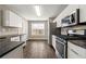 Bright kitchen with stainless steel appliances, granite countertops and laminate flooring at 2043 Ridgestone Sw Lndg, Marietta, GA 30008