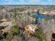 Stunning aerial view of the home nestled on a wooded lot with lake access, showcasing its serene setting at 210 Lawn Market, Sharpsburg, GA 30277